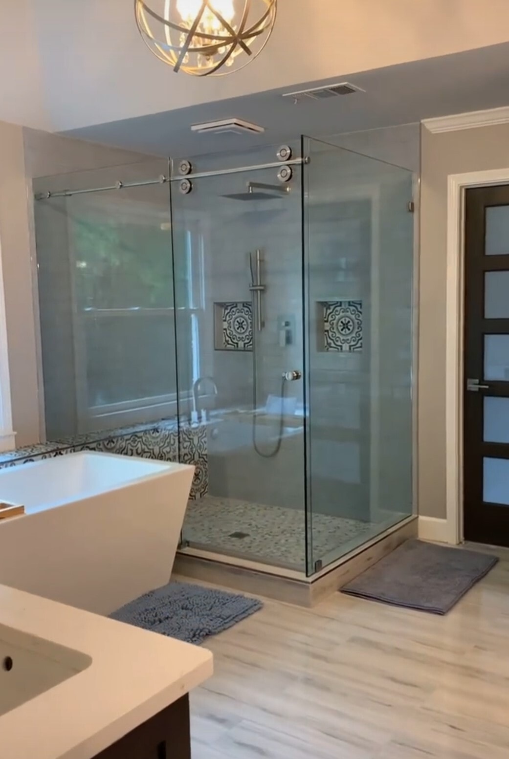 Stunning Crescent series sliding shower door with a return panel and a Euro style knob.