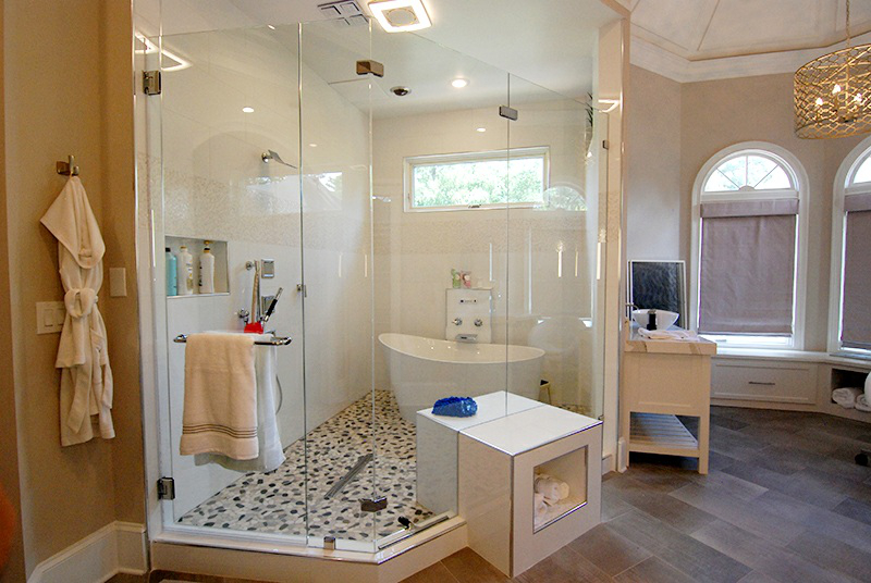 This shower enclosure is particularly special as we cut the glass to incorporate the square bench/cubby. 