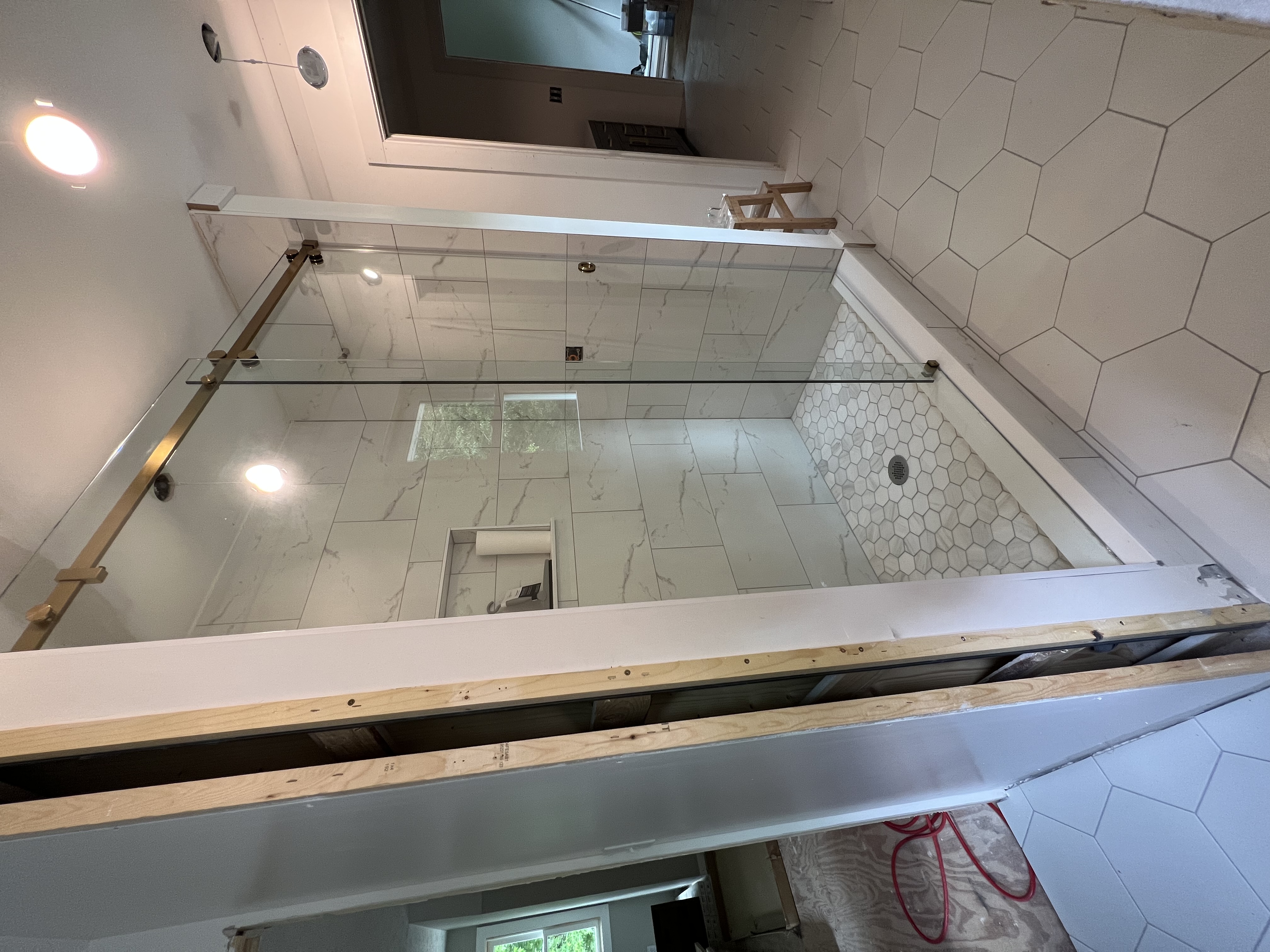 This brushed gold sliding system is a beautiful way to complete a bathroom remodel!