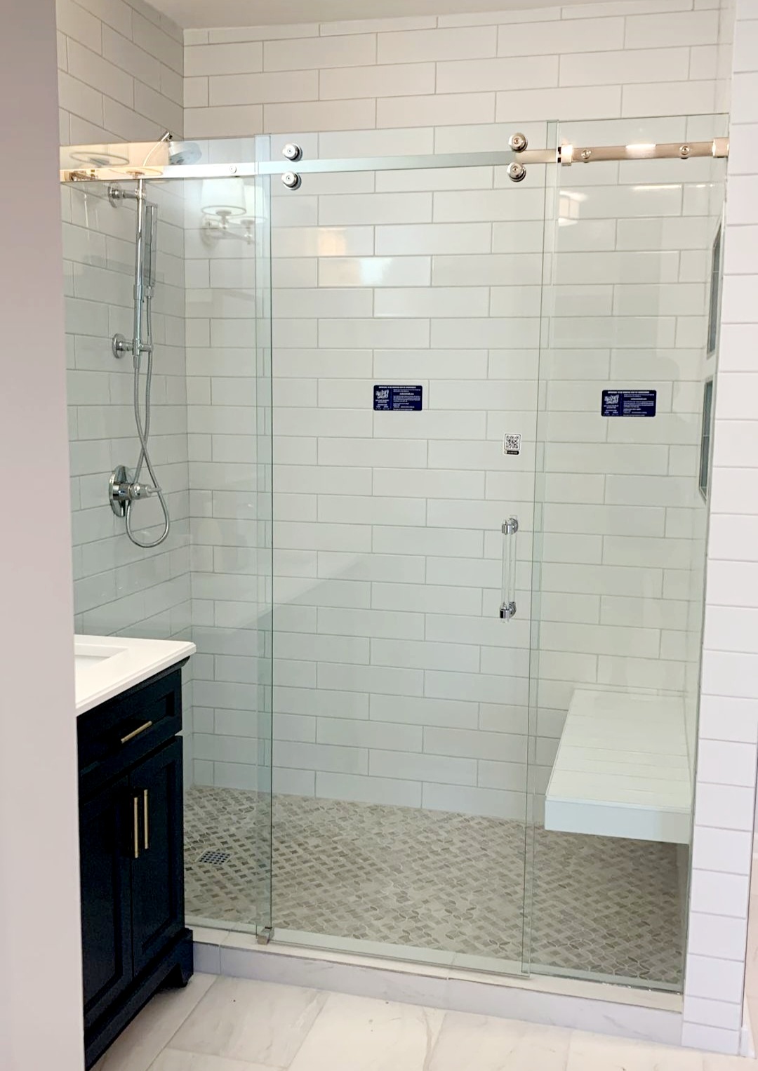 This is a Serenity slider from CR Laurence! The rollers are smaller and sleeker in appearance than the Crescent slider, however, the function is the same. This shower also features a GLASS handle from Portals Luxury Hardware!