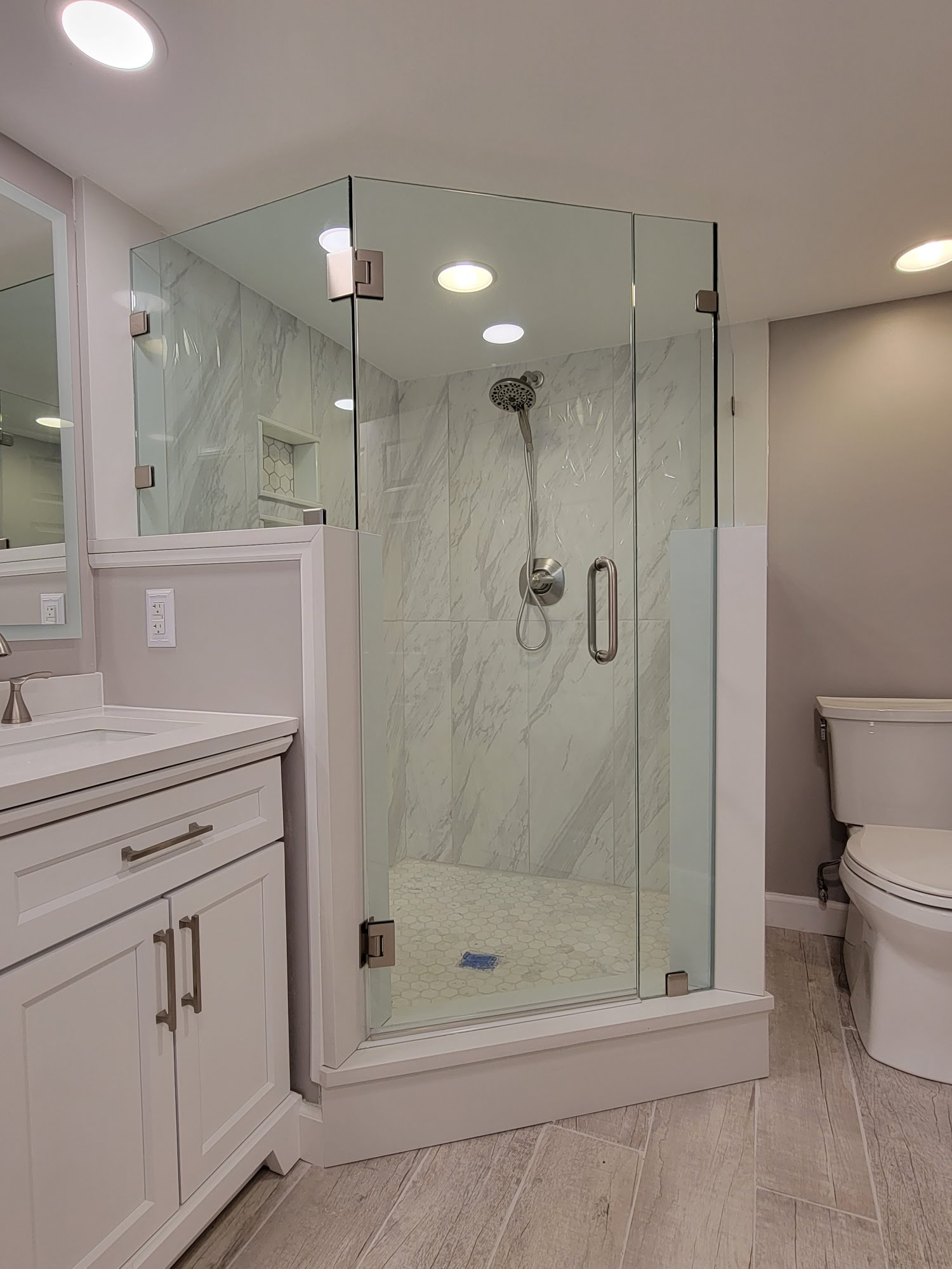 This installation was an incredibly tricky situation because the half walls terminate into the curb at an angle. Check out our blog post on shower door design for more information! https://www.showerdoorguy.com/blog/the-dos-and-donts-of-shower-design-b8ea20b0c88eaae3