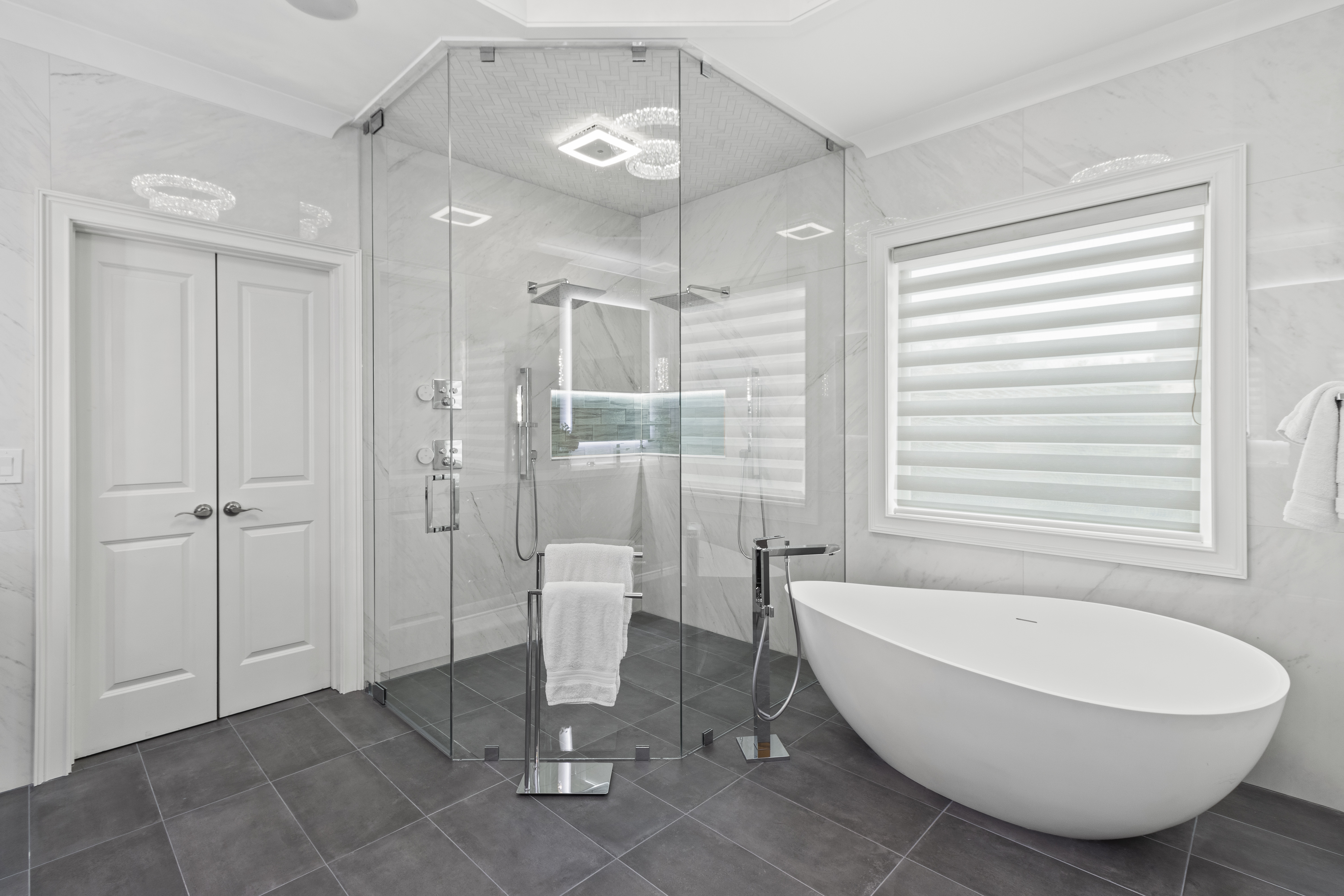 This stunning neo-angle shower completes the luxurious look of this new bathroom remodel by Stephenson Construction. 
