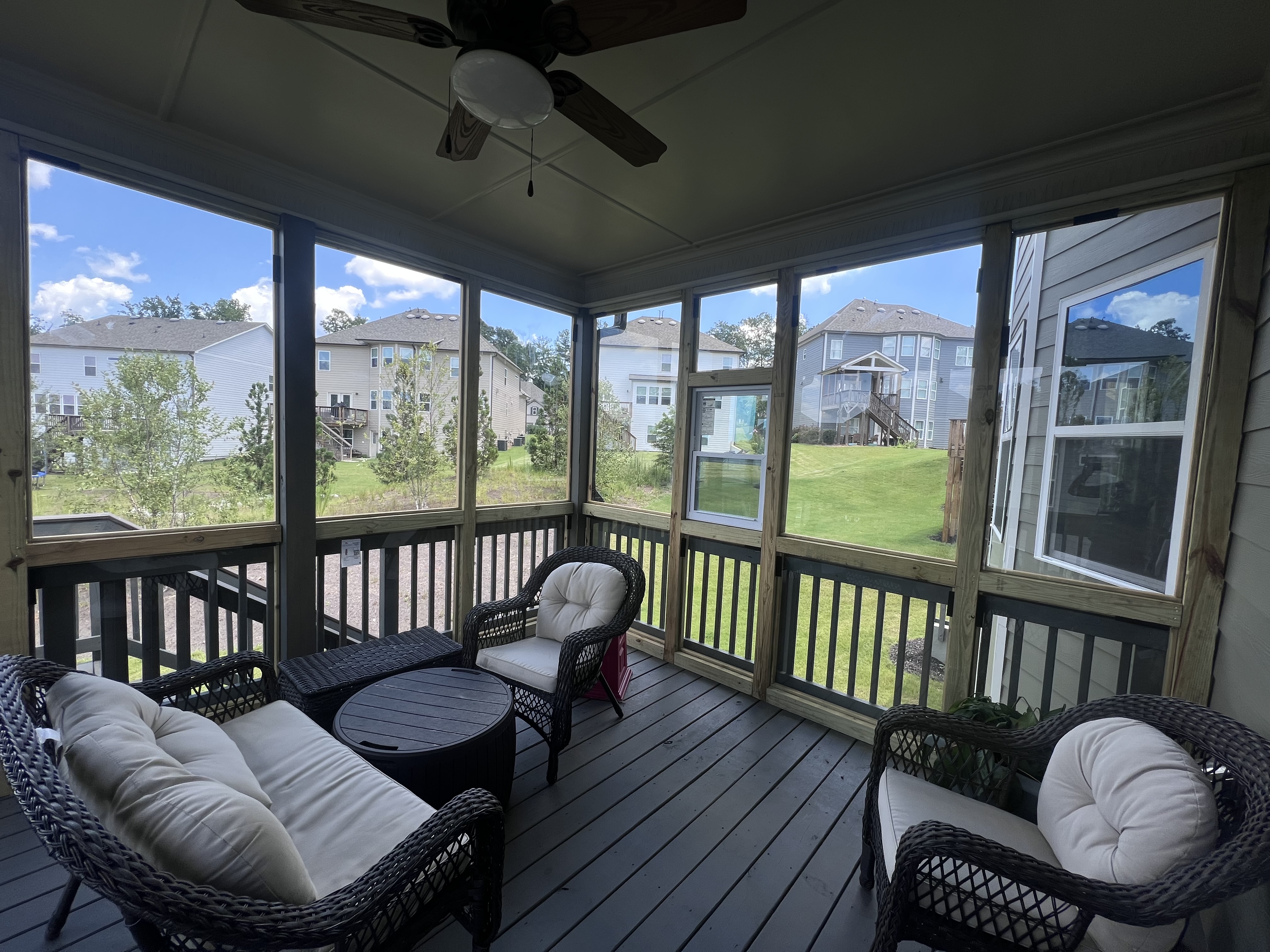 This back porch is enclosed with glass for a clear view of the gorgeous back yard!