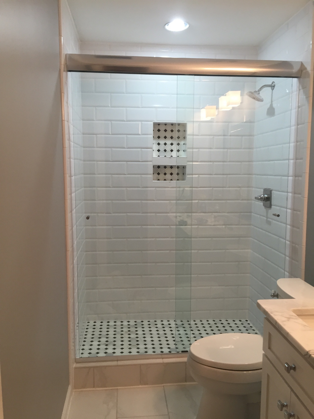 Regular clear glass was used on this shower; OptiWhite would be an awesome option to consider for a cleaner look!